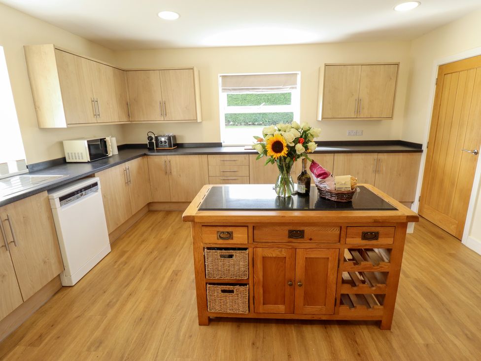 A kitchen with cabinets, countertop, and appliances at Wold View near Caistor