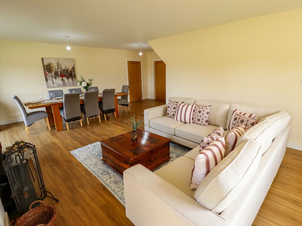A living room with a sofa and a dining area at Wold View near Caistor