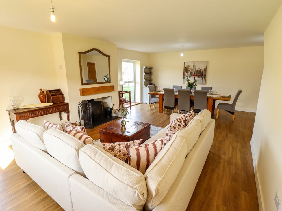 A living room with a sofa and dining area at Wold View near Caistor