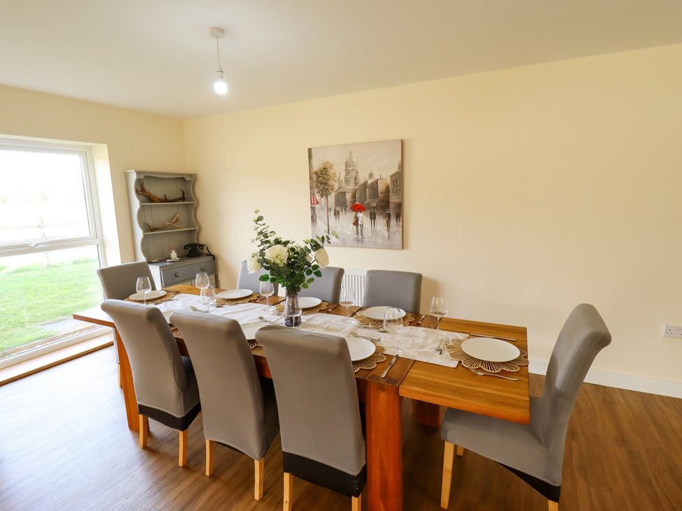 A dining room with a wooden table and chairs at Wold View near Caistor