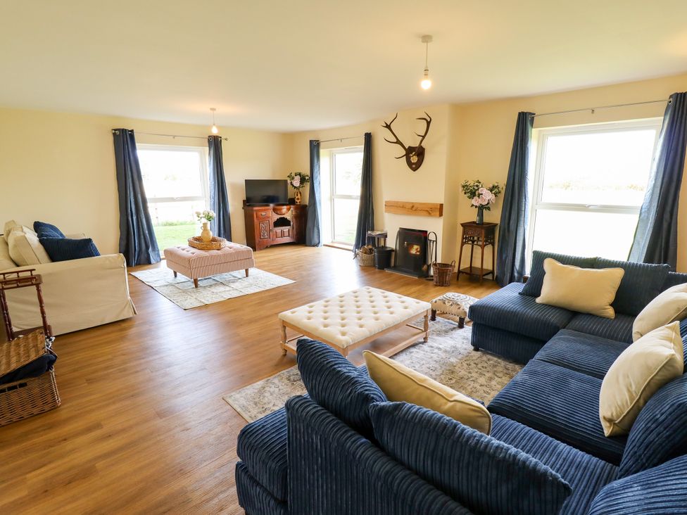 A living room with sofa, coffee table, and television at Wold View near Caistor