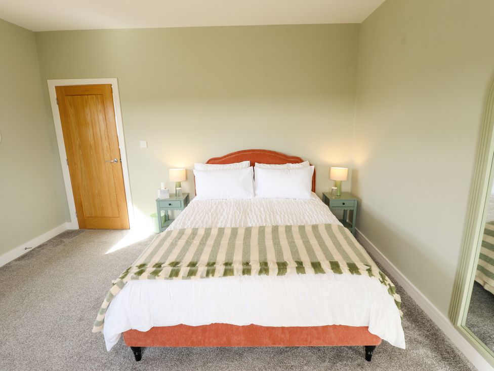 A bedroom with a bed and nightstands at Wold View near Caistor