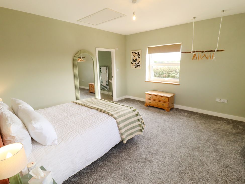 A bedroom with a bed and mirror at Wold View near Caistor