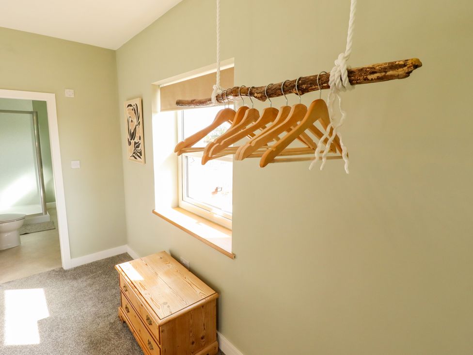 A bedroom with wooden hangers and a chest at Wold View near Caistor