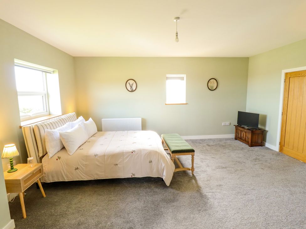 A bedroom with a bed and table at Wold View near Caistor