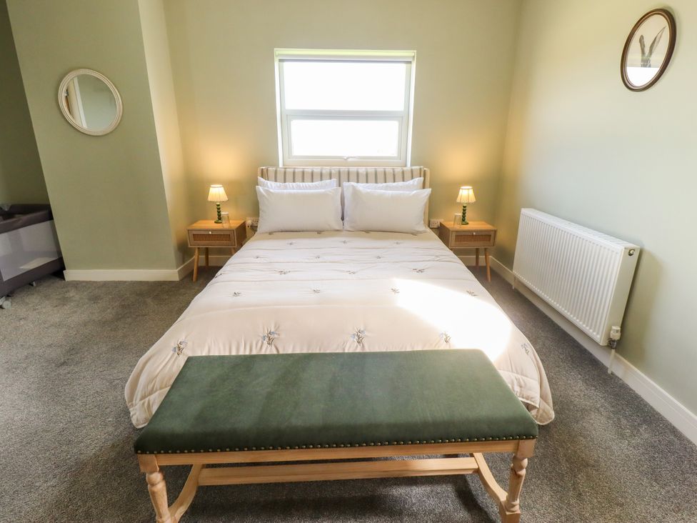 A bedroom with a bed and nightstands at Wold View near Caistor