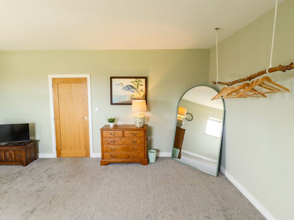 A bedroom with a dresser and mirror at Wold View near Caistor