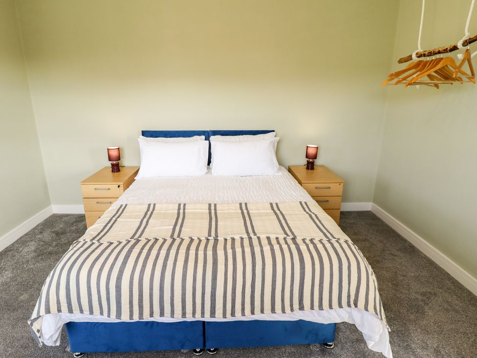 A bedroom with a bed and nightstands at Wold View near Caistor