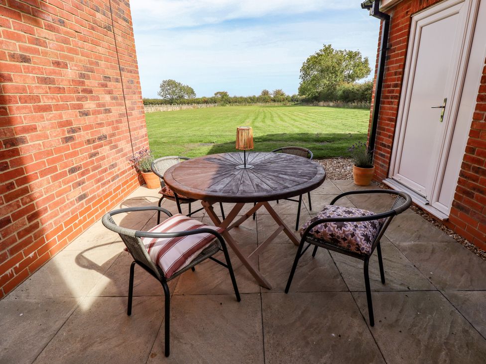 An outdoor seating area with a table and chairs at Wold View near Caistor