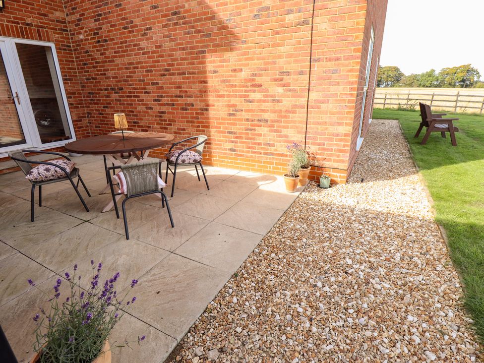 An outdoor seating area with a table and chairs at Wold View near Caistor