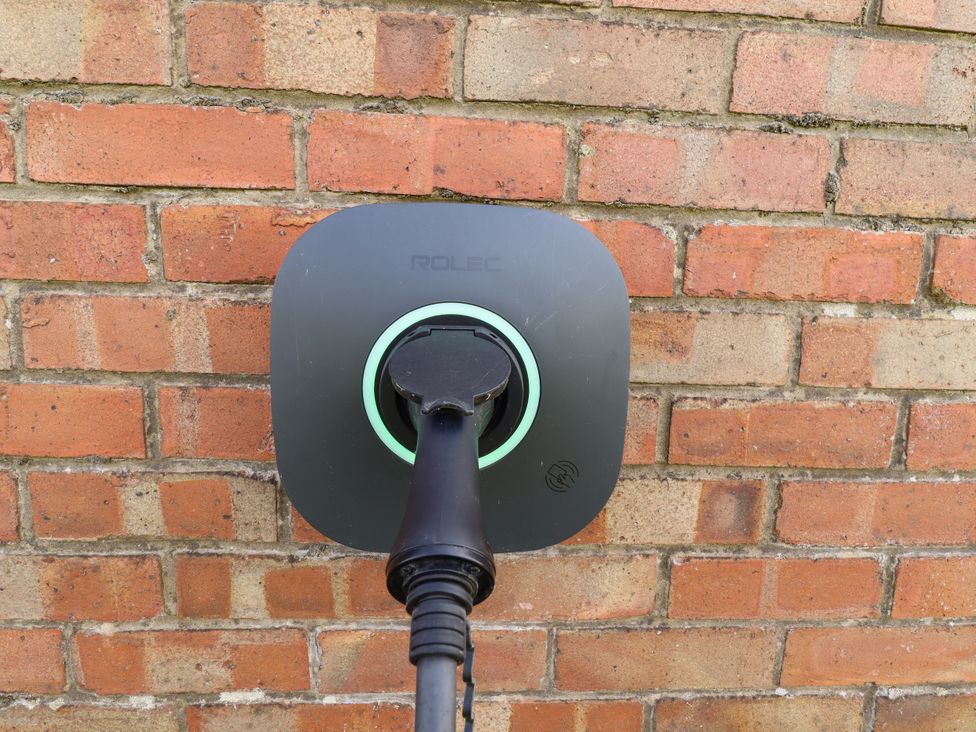 A charging point on a wall for electric vehicles at Wold View near Caistor
