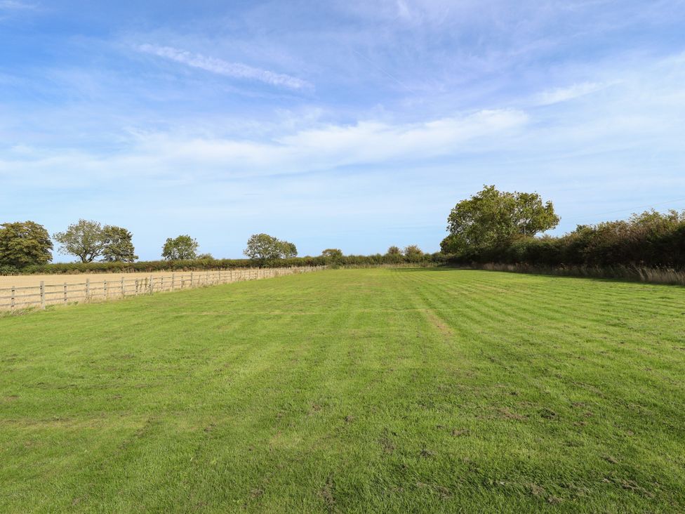 A wide open field with grass and trees at Wold View near Caistor