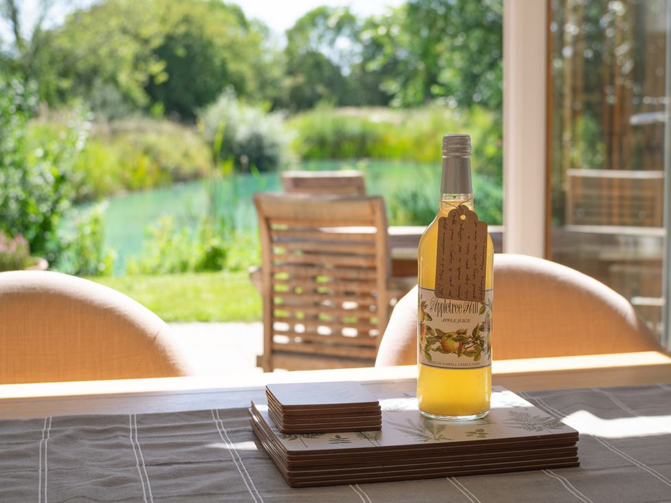 A dining room with apple juice on the table at Ash Lodge in Stowmarket