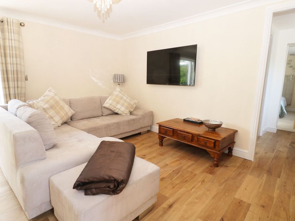 A living room with a sofa and a television at Millstone Cottage in Beverley