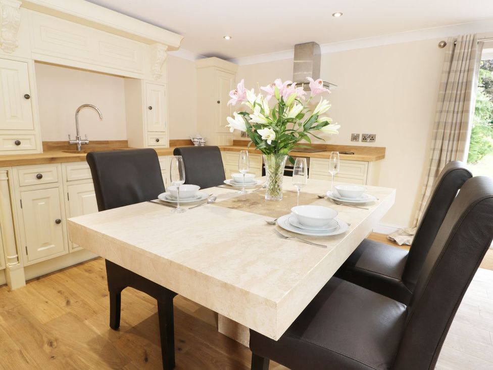 A kitchen with dining table and chairs at Millstone Cottage Beverley