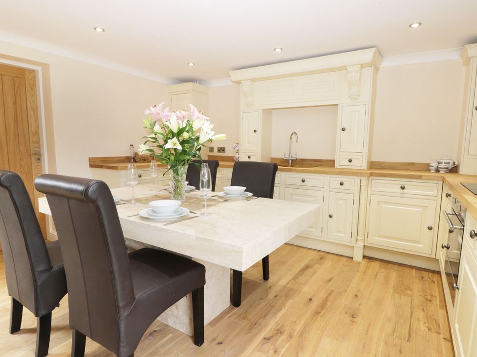 A kitchen with a dining table and sink at Millstone Cottage Beverley