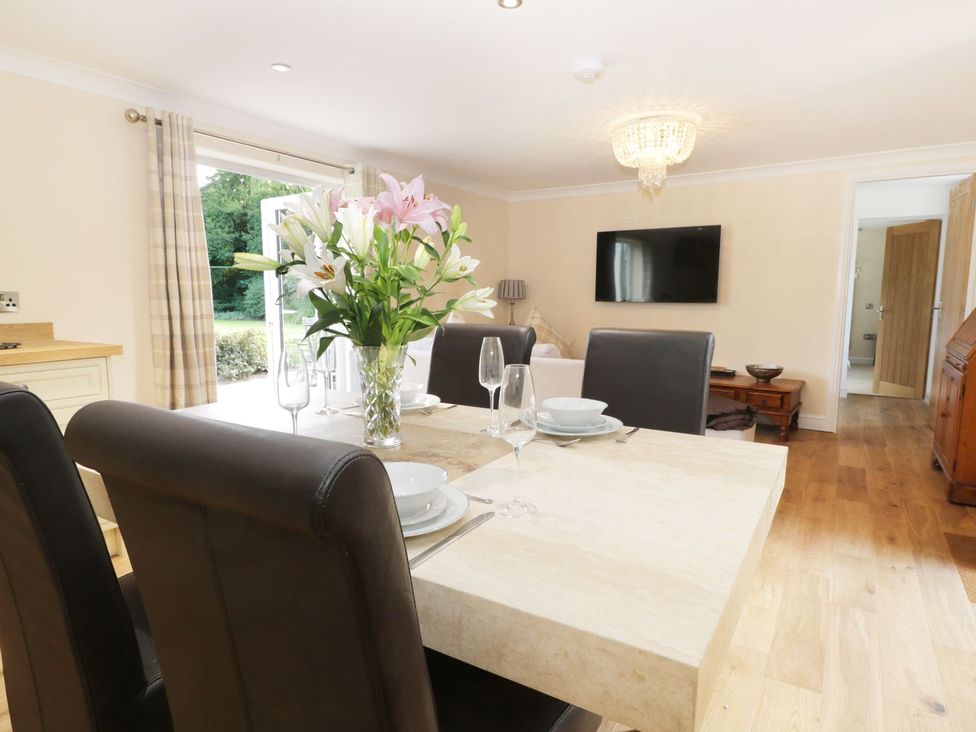 A dining room with a table set for a meal at Millstone Cottage in Beverley