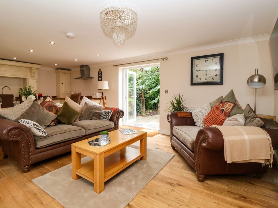 A living room with sofas and a table at Millstone Cottage Leven Near Beverley