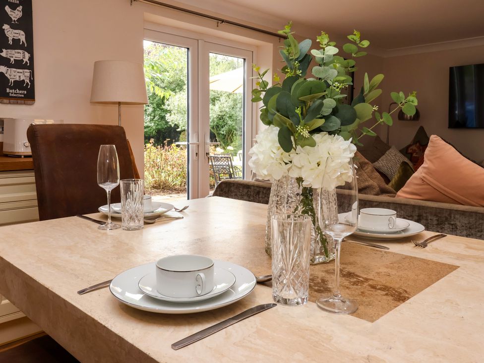A dining room with a table set for meal at Millstone Cottage Leven Near Beverley