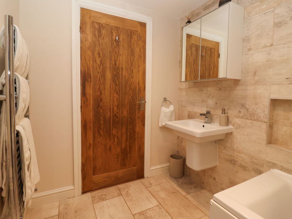 A bathroom with a sink and mirror at Millstone Cottage Leven Near Beverley