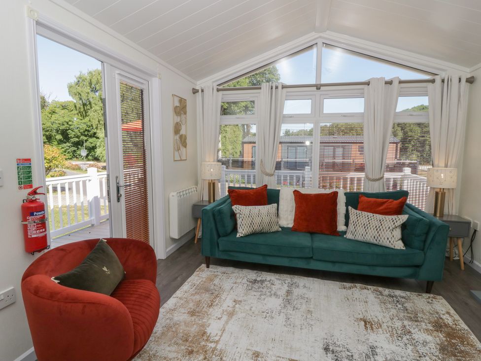 A living room with a sofa and armchair at 73 Cildraeth in New Quay