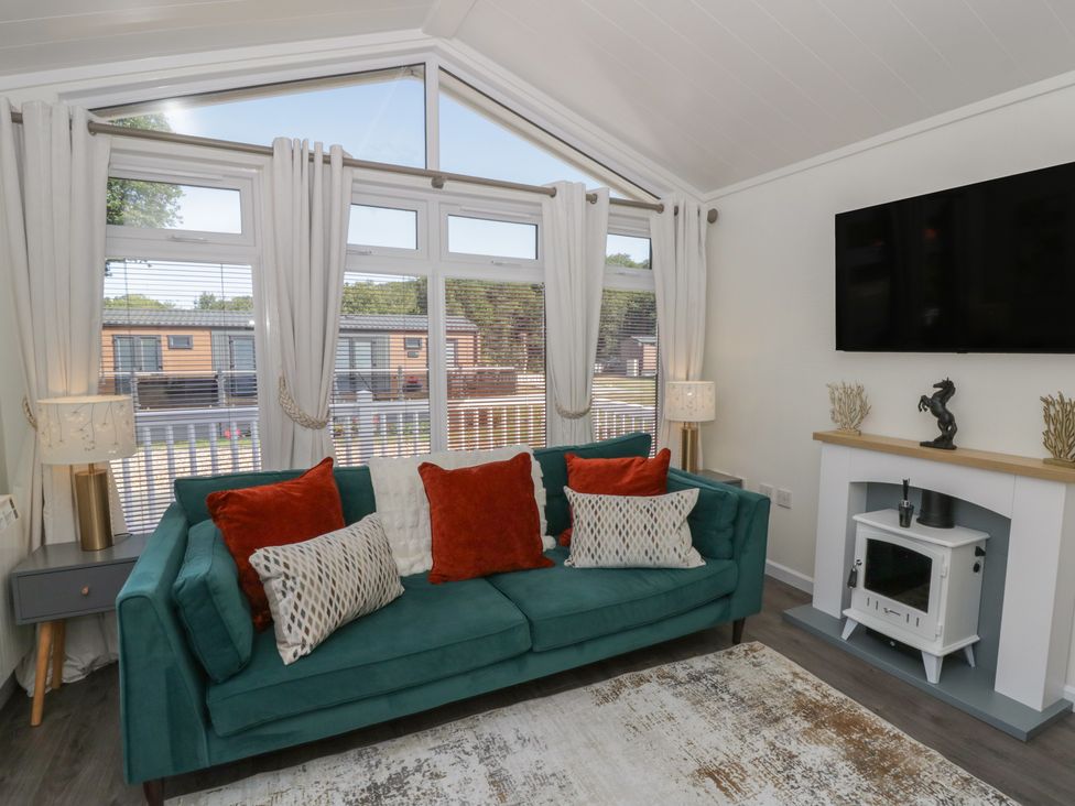 A living room with a sofa and television at 73 Cildraeth New Quay