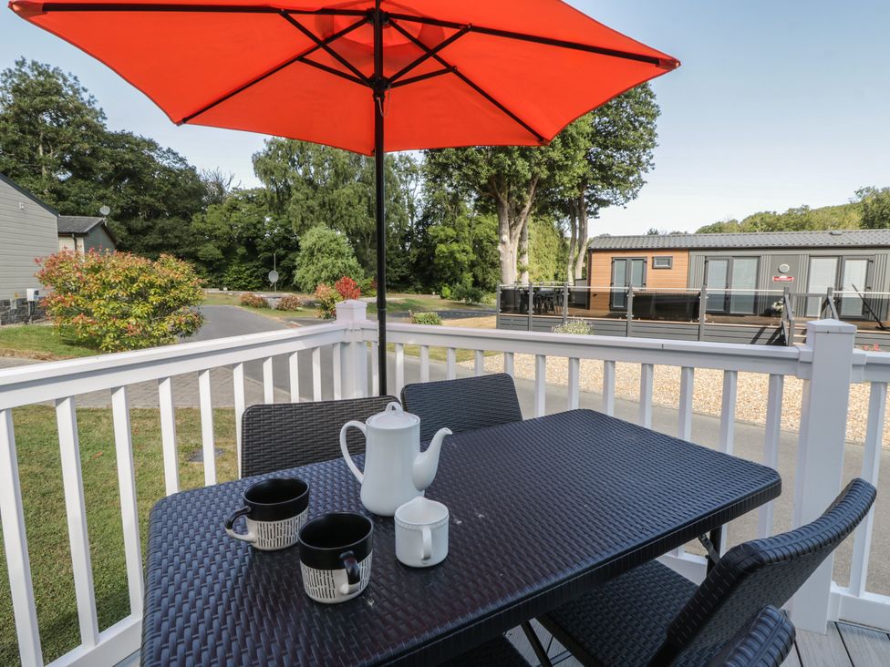 A patio table with an umbrella and tea set at 73 Cildraeth New Quay