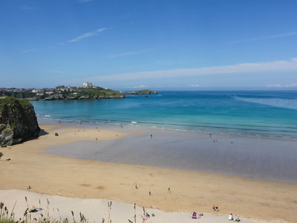 A beach with sand and people at Seaside Retreat in Newquay