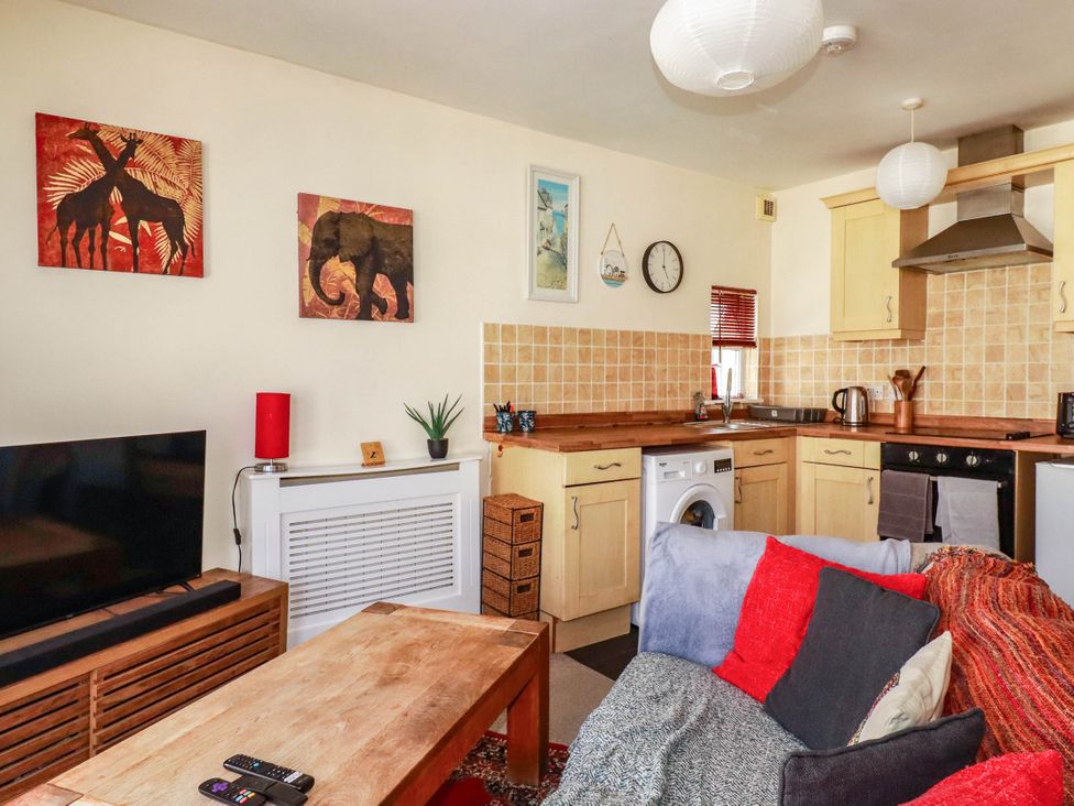 A living room with a sofa and tv at Seaside Retreat in Newquay