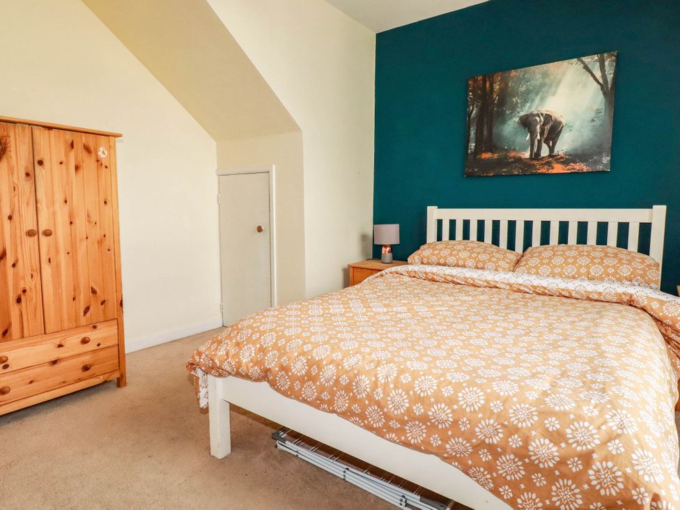 A bedroom with a bed and wardrobe at Seaside Retreat in Newquay