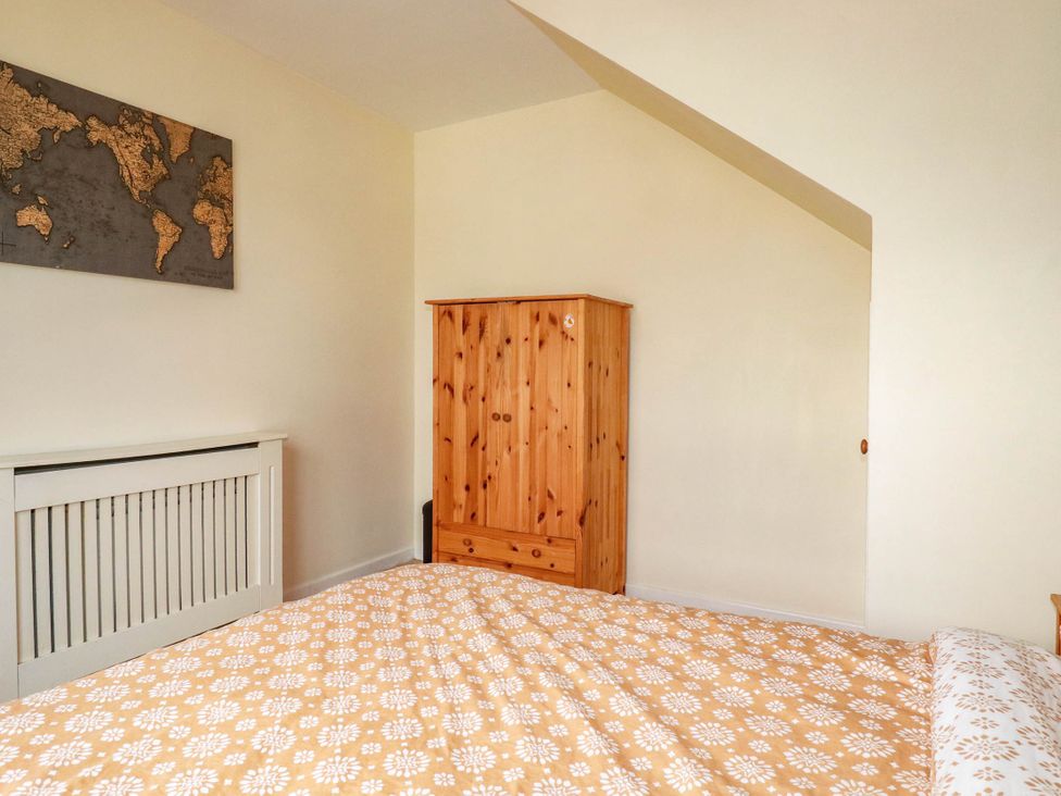 A bedroom with a bed and wardrobe at Seaside Retreat in Newquay