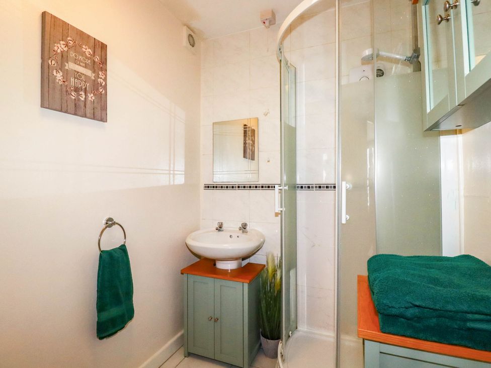 A bathroom with a shower and sink at Seaside Retreat in Newquay