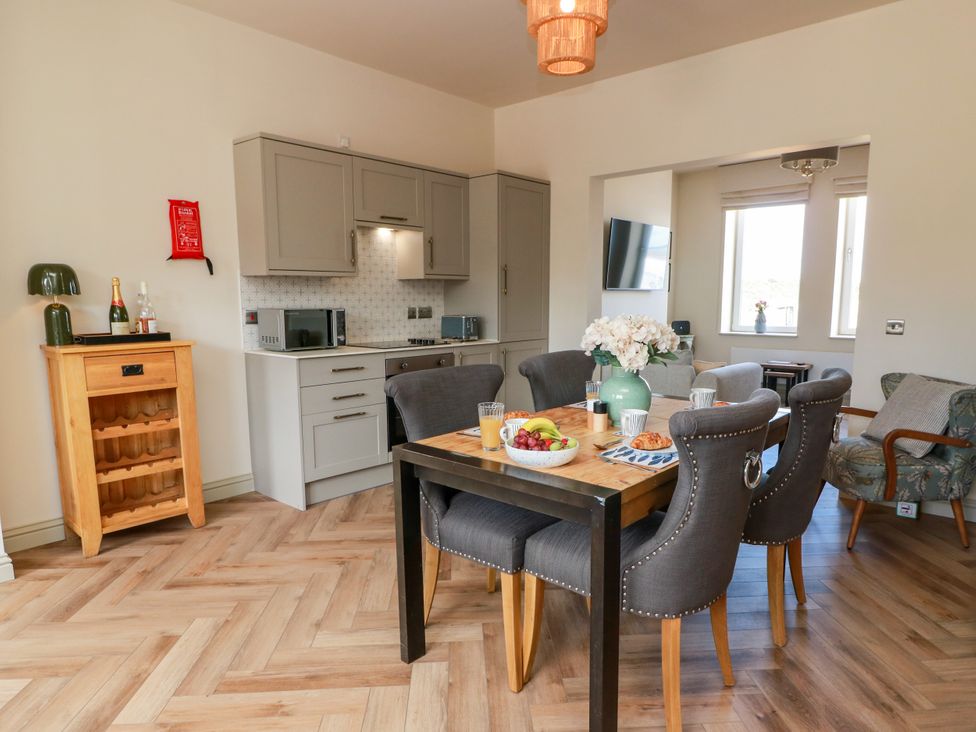 A dining room with a table and chairs at Sandy Toes, Powfoot, Annan