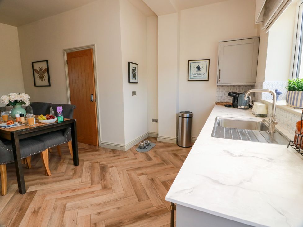 A kitchen with a dining table and chairs at Sandy Toes, Powfoot, Annan
