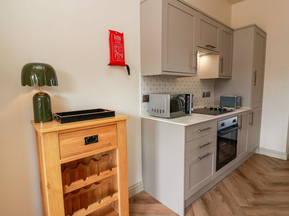 A kitchen with cabinets and appliances at Sandy Toes, Powfoot, Annan