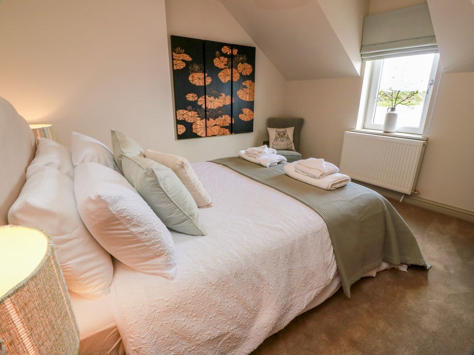 A bedroom with a bed and pillows at Sandy Toes, Powfoot, Annan