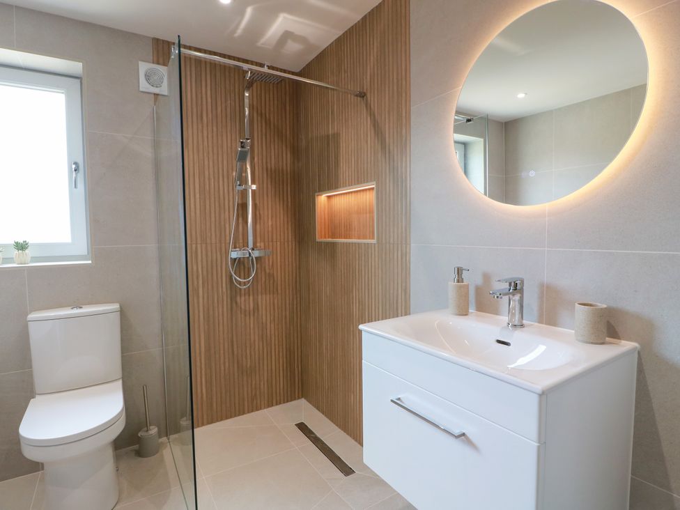 A bathroom with a shower and sink at Sandy Toes, Powfoot, Annan