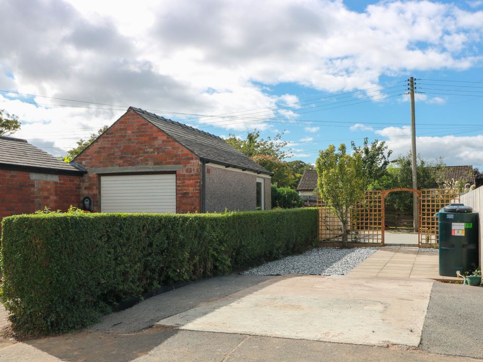 An outdoor area with a garage and gravel path at Sandy Toes in Powfoot, Annan