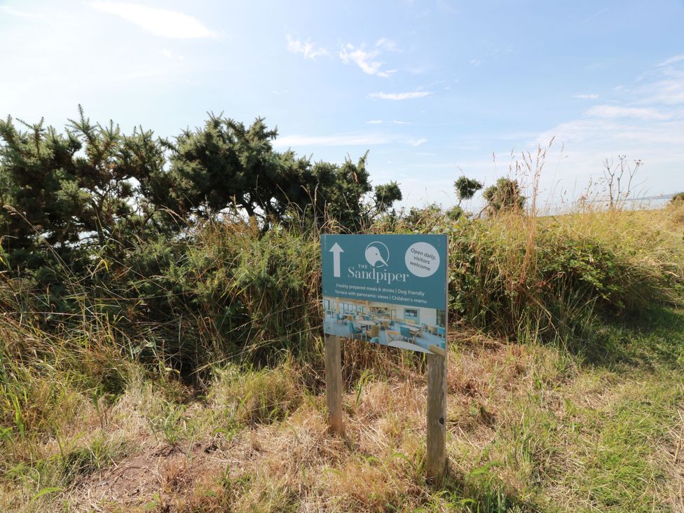 A sign for The Sandpiper with information outdoors at Sandy Toes in Powfoot, Annan