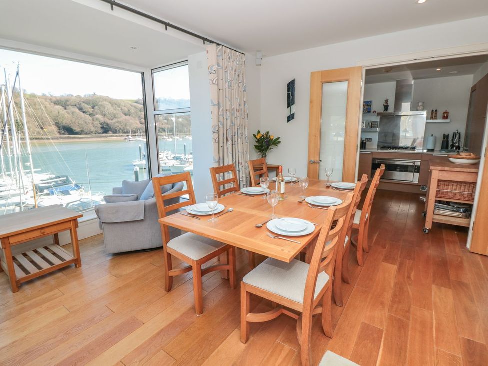 A dining room with a table and chairs near the window at 33 Dart Marina Dartmouth