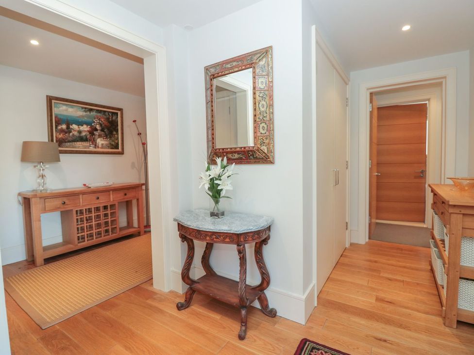 An entrance hall with a console table and mirror at 33 Dart Marina Dartmouth