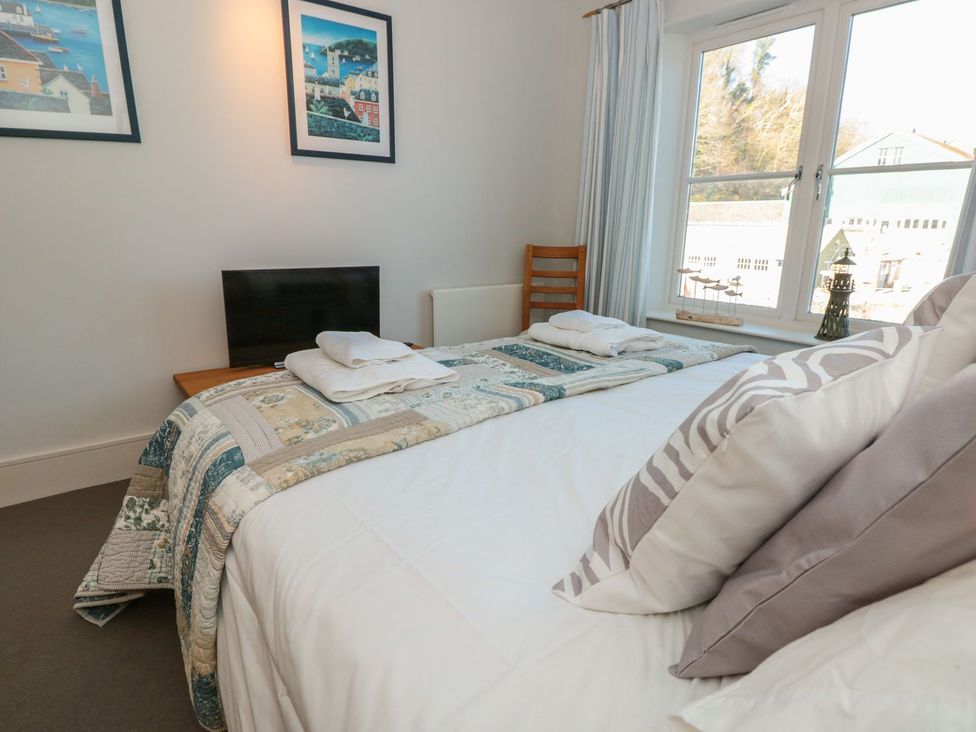 A bedroom with a bed and a television at 33 Dart Marina in Dartmouth