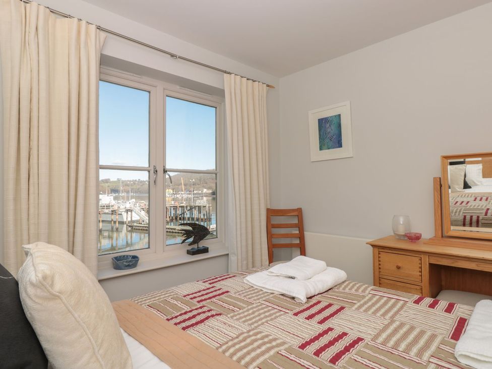 A bedroom with a bed and a desk at 33 Dart Marina Dartmouth