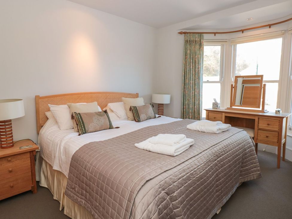 A bedroom with a double bed and desk at 33 Dart Marina Dartmouth