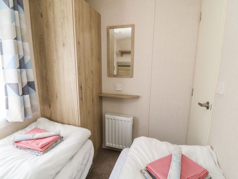 A bedroom with twin beds and a wardrobe at Cox Tor in Tavistock