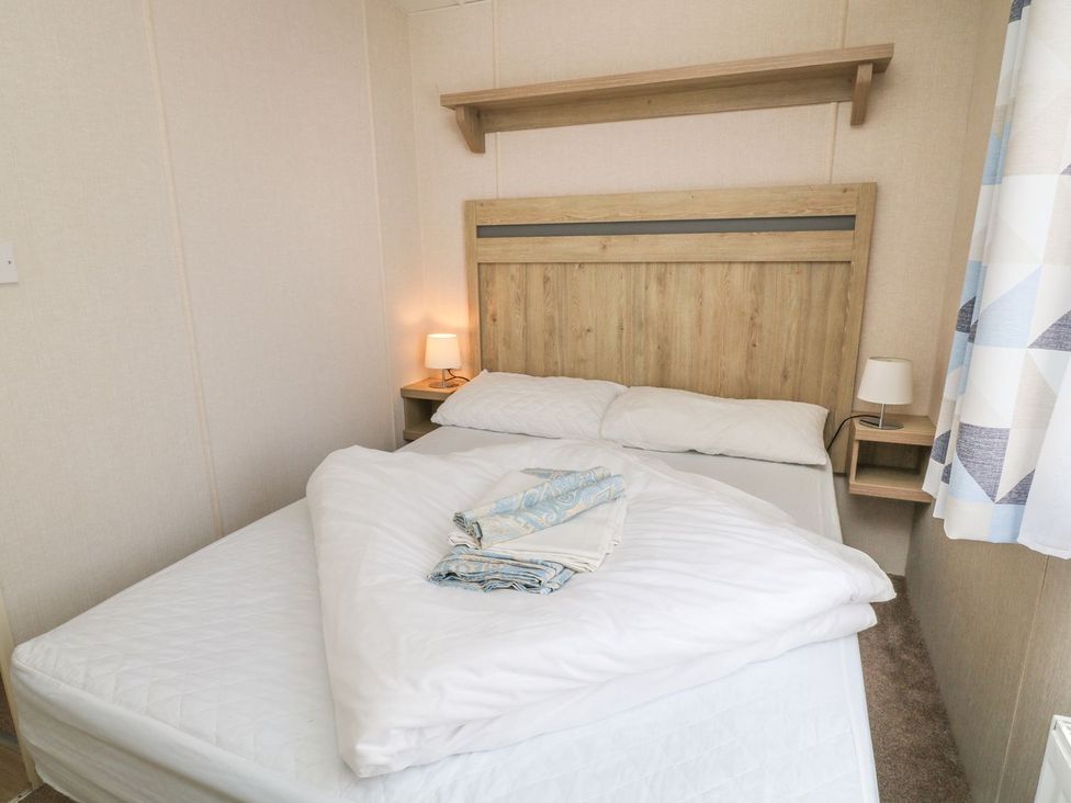 A bedroom with a bed and nightstand at Cox Tor in Tavistock