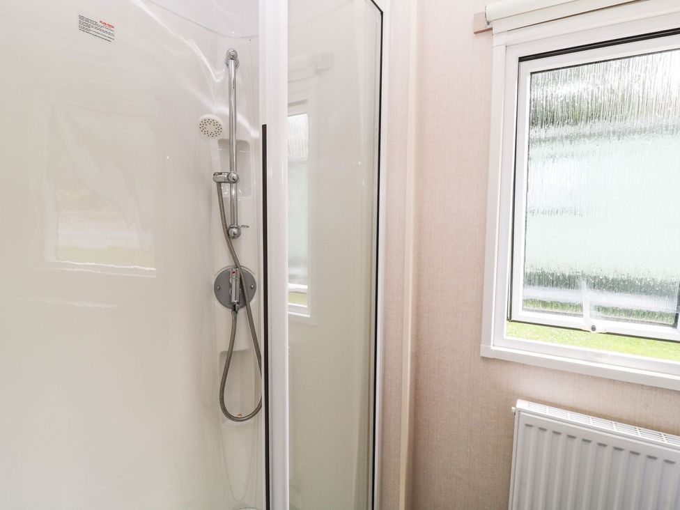 A shower enclosure with a window in the bathroom at Cox Tor in Tavistock