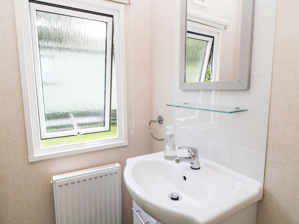 A bathroom with a sink and mirror at Cox Tor Tavistock