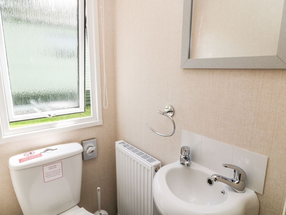 A bathroom with a toilet and sink at Cox Tor in Tavistock