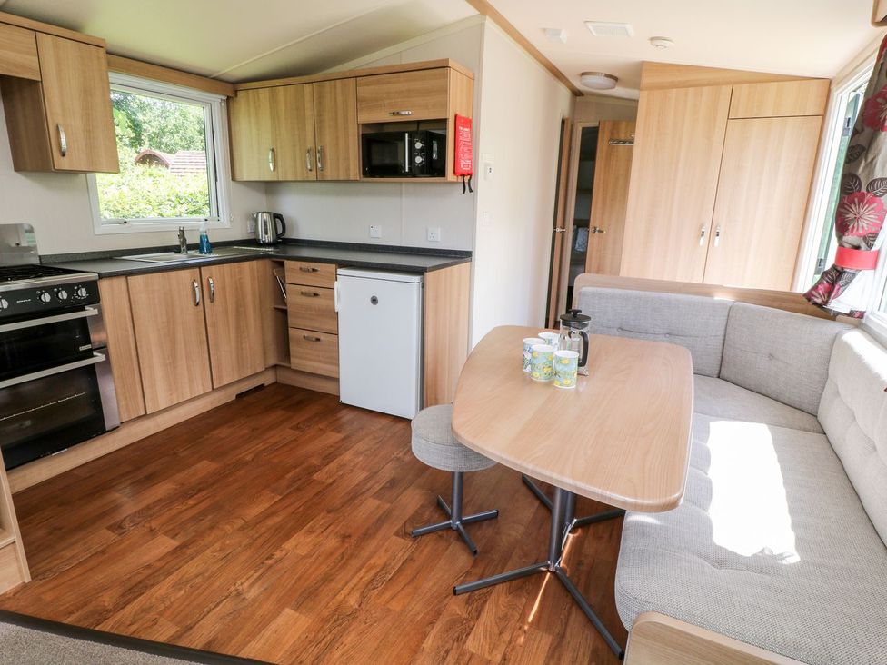 A kitchen with cabinets, appliances and a dining area at Brent Tor in Tavistock